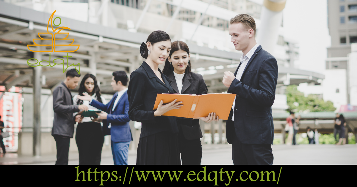 Young professionals in formal attire reviewing documents representing career opportunities for engineering graduates
